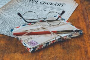 Image of reading glasses next to a pen